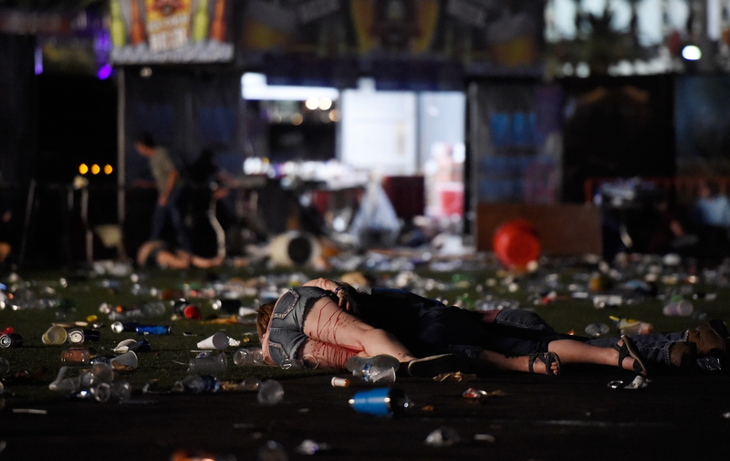 A person lies on the ground covered with blood at the Route 91 Harvest country music festival after gun fire was heard on October 1, 2017 in Las Vegas, Nevada. (Photo by David Becker/Getty Images)